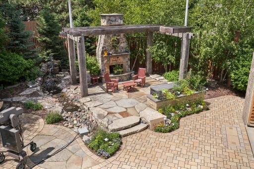 permeable paver patio with custom pergola and fireplace